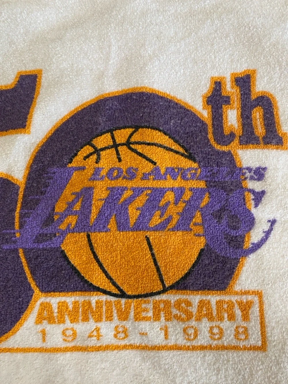 Los Angeles Lakers 50th anniversary towel with team's commemorative logo.